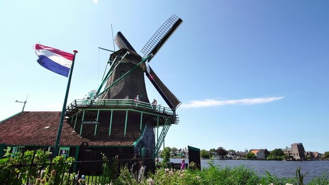Tourists taking pictures of iconic Windmills at the Zaanse Schans near Amsterdam, Holland