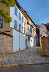 Fototapeta na wymiar Large three-story white-washed historical timber house in Erfurt, Germany