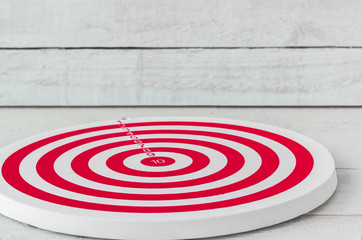 Dartboard on white wood.