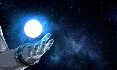 Moon planet in spaceman hand. Mixed media