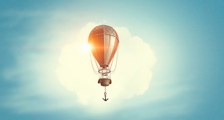 Air balloon in blue sky. Mixed media