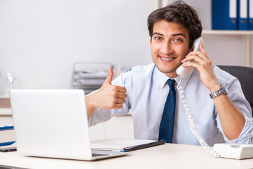 Young call center operator speaking on phone