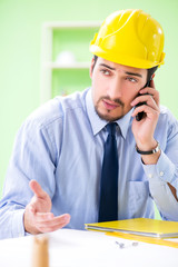 Young male architect working at the project