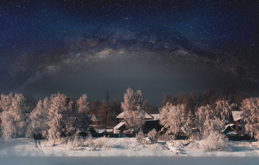 Winter landscape, forest covered by snow with sky full of stars