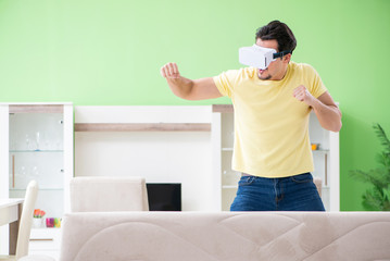 Fototapeta na wymiar Young man with virtual reality goggles