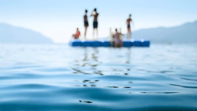 4k blurred video of people relaxing and having fun on pontoon at sea