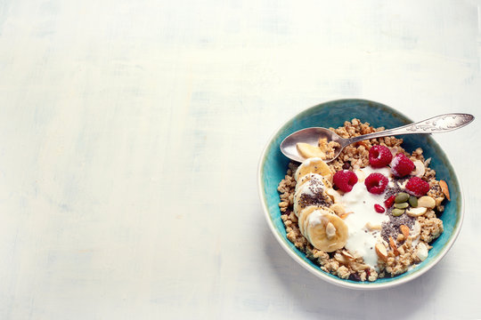 Bowl of granola with yogurt and fresh berries