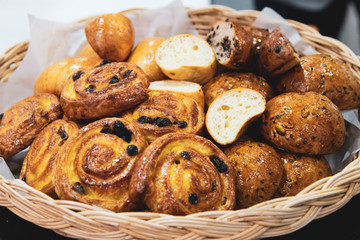 French croissants on wicker basket, bakery background
