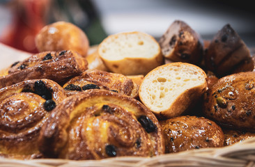 French croissants on wicker basket, bakery background