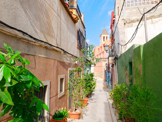 Fototapeta na wymiar Beautiful narrow alley in the old town of Alicante. Spain