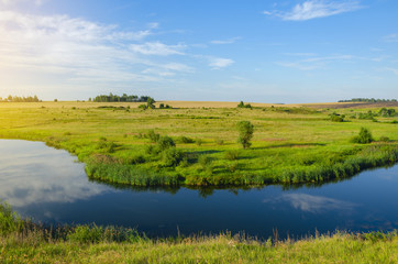 Sunny summer landscape with fields,river and beautiful woods.