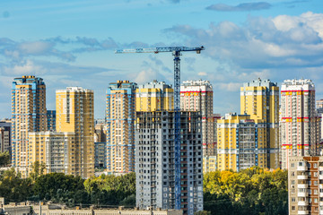 Construction of a new house on the background of the urban landscape .