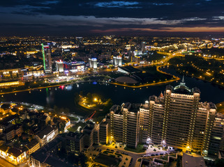 Fototapeta na wymiar City illumination at midnight. Modern residential and office buildings, aerial top view. Minsk, Belarus