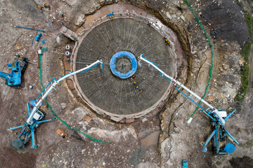 Aerial view construction worker pouring concrete foundation by concrete pump machine at construction site
