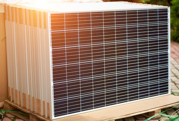 Close-up of new solar photo voltaic modules set outdoors ready for buying, transportation and...