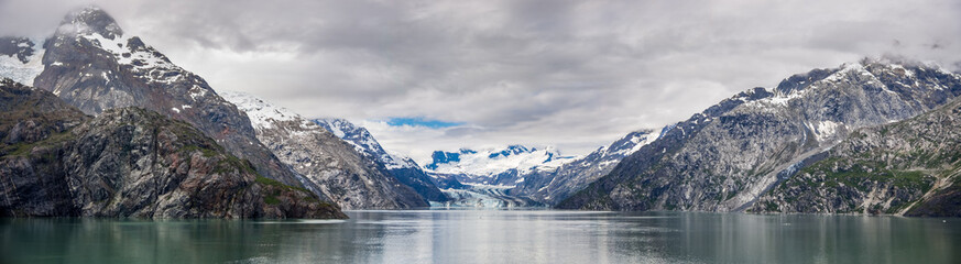 Fototapeta na wymiar Johns Hopkins Glacier and mountains on a cloudy day in Glacier Bay National park Alaska