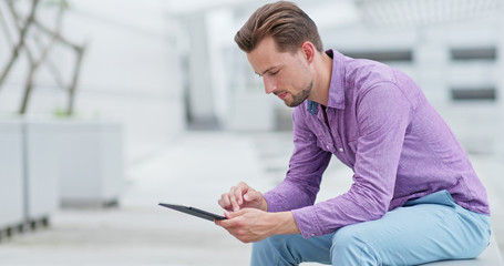 Man use of tablet computer at outdoor