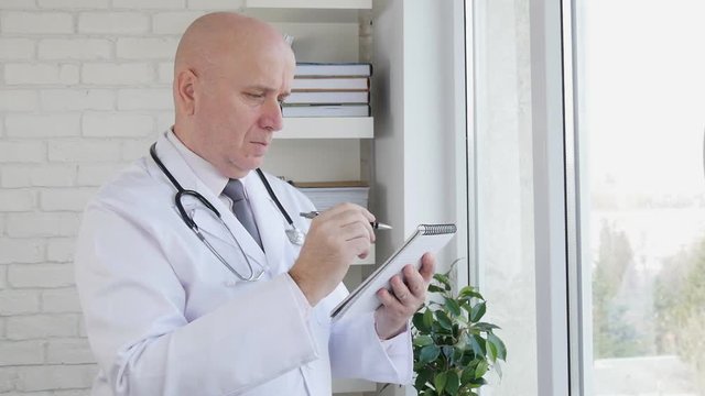 Slow Motion with Doctor Interior Hospital Taking Notes Using a Pen and Agenda 
