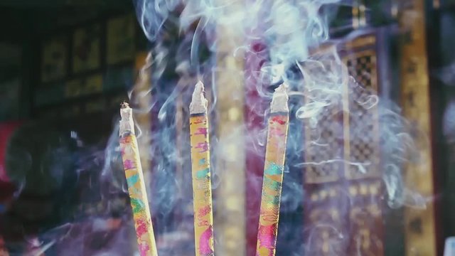 Incense sticks burning in a Buddhist temple in China slow motion