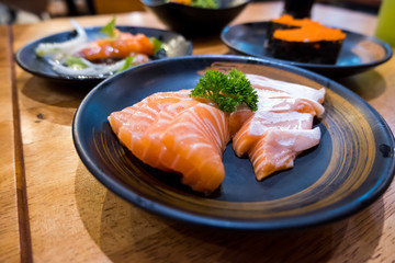Fresh raw salmon on black plate