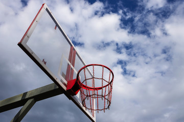 basketball basket against the sky with clouds