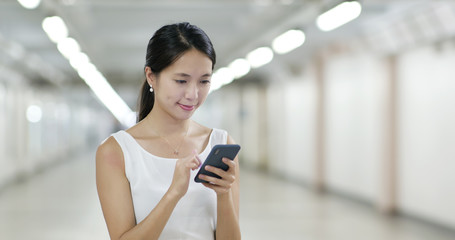 Fototapeta premium Woman look at smart phone in the evening