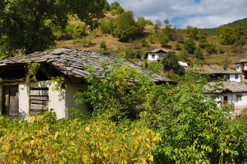 Fototapeta na wymiar Old houses in the historical cultural reserve village of Dolen, Bulgaria. Dolen is famous with its 350 old houses – an example of 19th century Rhodopean architecture. 