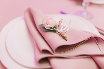Dining table setting at Provence style, with small rose flower, beige napkin. Close-up horizontal view