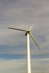 wind generator on blue sky background. electricity production. place for text