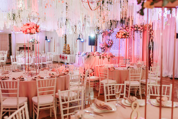 Table 8 set for wedding or another catered event dinner. Luxury decorated with natural flowers