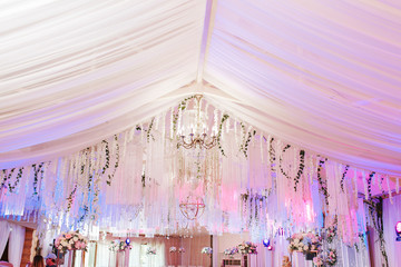 Table 8 set for wedding or another catered event dinner. Luxury decorated with natural flowers