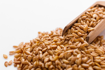 Seeds of golden flax on a white background