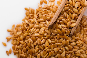 Seeds of golden flax on a white background