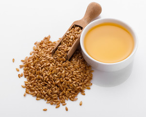 Seeds of golden flax on a white background