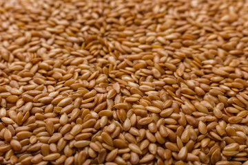 seeds of golden flax on a dark stone background
