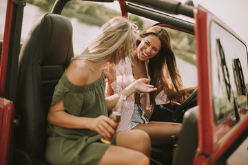 Attractive young women in a convertible car