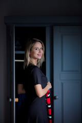 Young girl choose a sweater at home near wardrobe in bedrood. interior in Dutch style