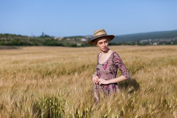 Naklejka na ściany i meble beautiful woman farmer in field of wheat farm