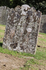 Close up of old gravestone tombstone in graveyward
