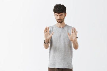 Let us stop and slow down. Portrait of intense angry and uninterested caucasian guy frowning...
