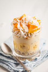 Overnight oatmeal with mango, coconut, banana and chia seeds.