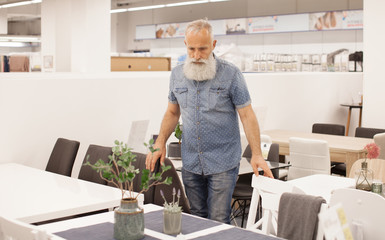 Man choosing home furniture in shop