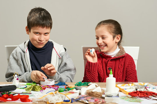Childrens making decorations for new year holiday. Painting watercolors. Top view. Artwork workplace with creative accessories.