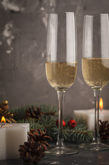 Christmas background with candles and glasses of champagne. Christmas card concept.