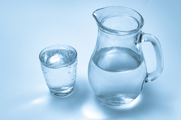 A glass of water and a jug
