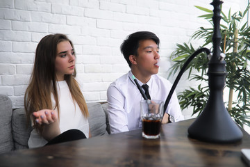 A pair of young people talking at the office