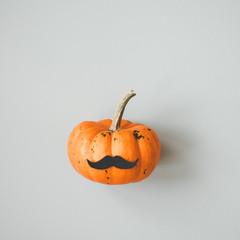 Halloween pumpkin Jack o Lantern with mustache on gray background