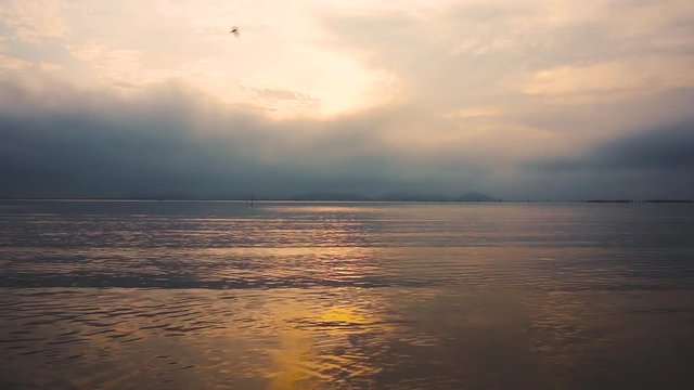Morning light. Tranquil scene of sunrise with cloudy sky over seascape, serenity background.