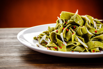 Pasta with cheese on wooden table
