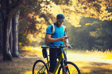 Obraz premium bearded man cyclist rides in the forest on a mountain bike.